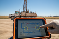 Hydraulic system schematic on rugged tablet in oilfield setting